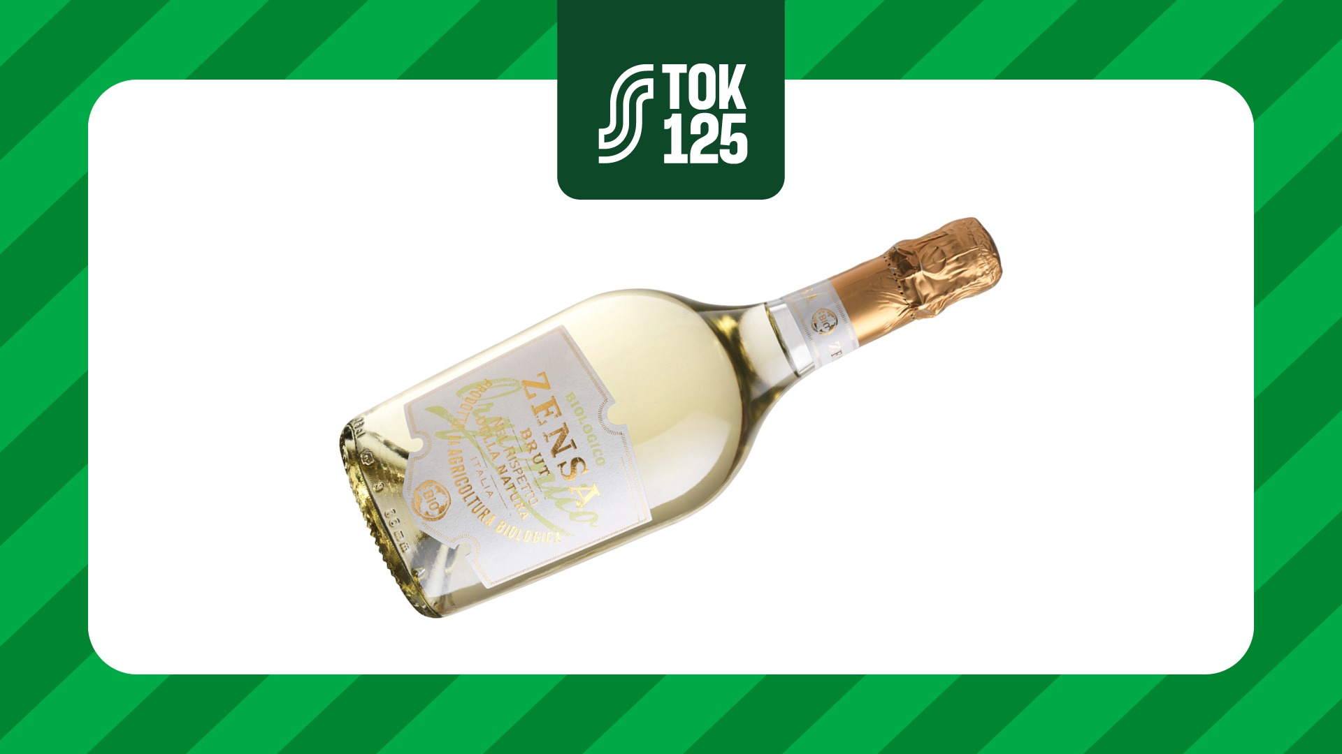 Champagne bottle with gold foil capsule and pale yellow liquid against green background.