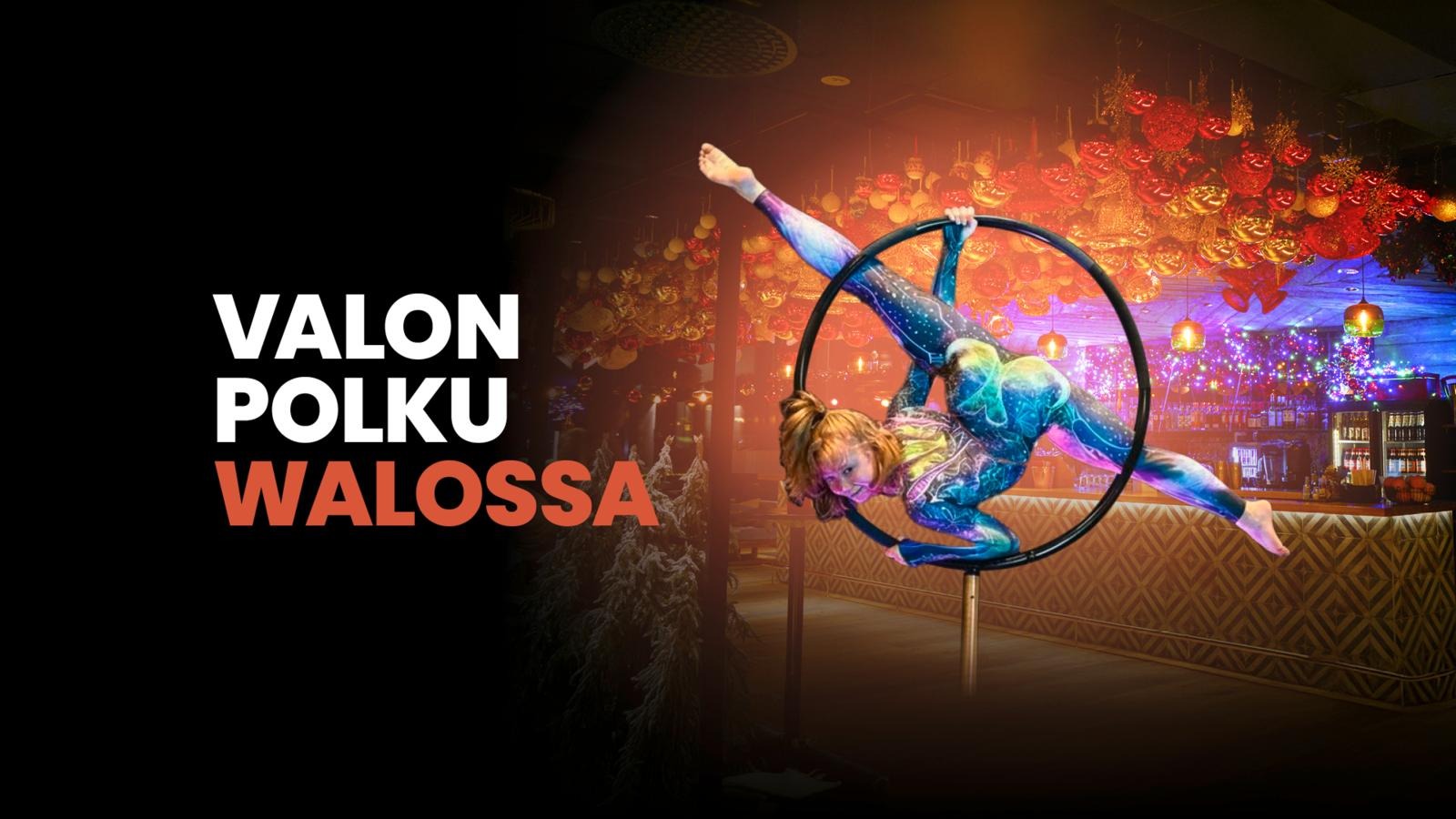Circus performer executing an aerial hoop routine in dramatic lighting. Colorful lights and decorative elements glow in the background.