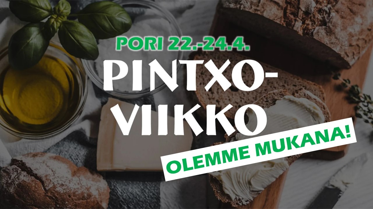 Närbild av en tallrik med brunt bröd, olivolja och basilikablad i bakgrunden.