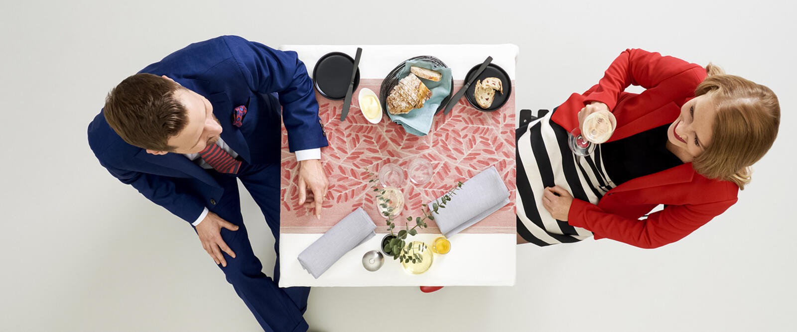 Coffee break photographed from above with two people sitting at a white table.