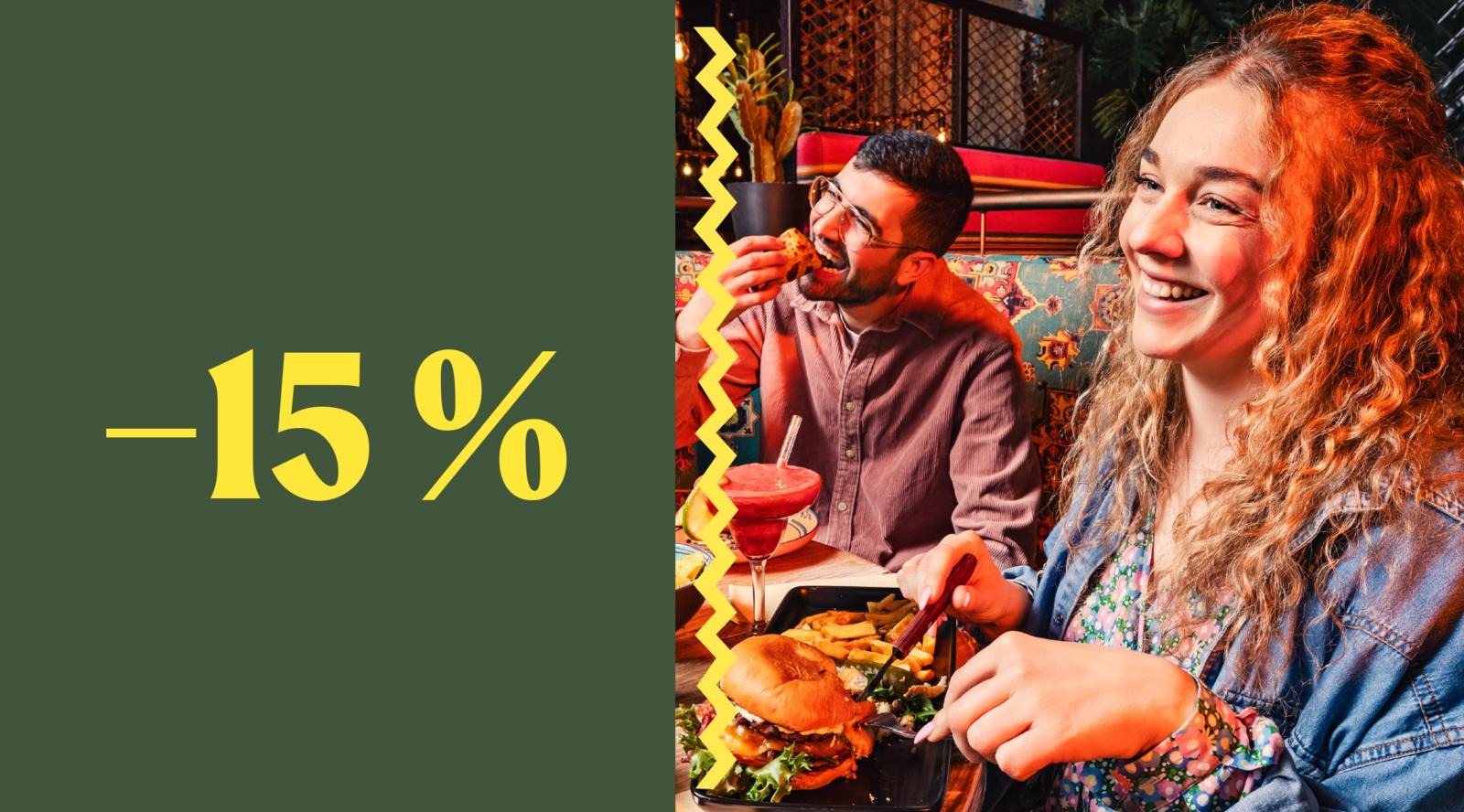 Two people enjoying food and drinks at a restaurant with colorful seating. Left side shows a green background with yellow -15% text.