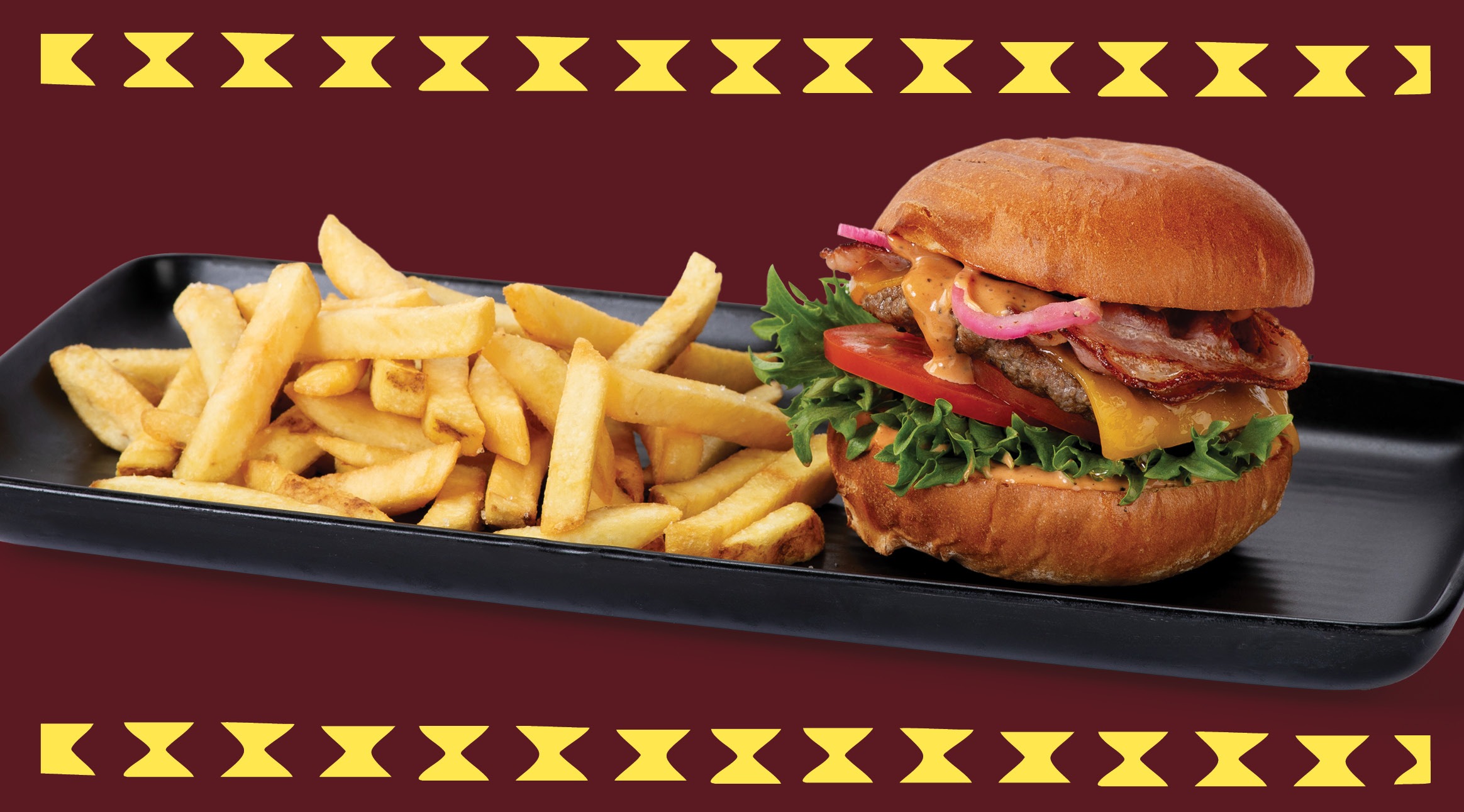 Burger and french fries on black serving tray.