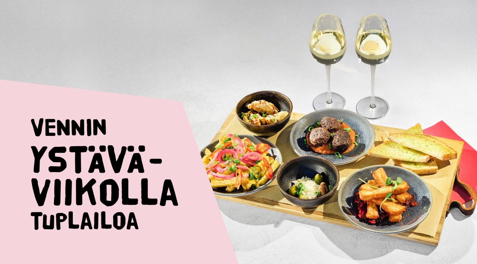 Puisia tarjoilulautanen, jolla viisi annosta tapaksia, vieressä toasteja ja kaksi lasia valkoviiniä.