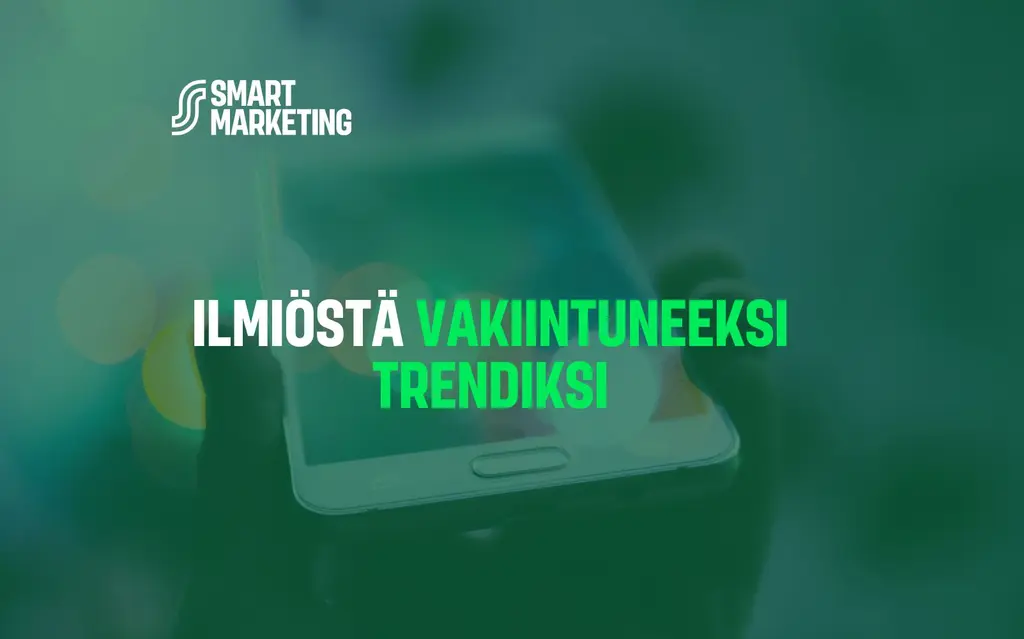 Vihreä tausta älypuhelimella, jonka päällä lukee: ilmiöstä vakiintuneeksi trendiksi.