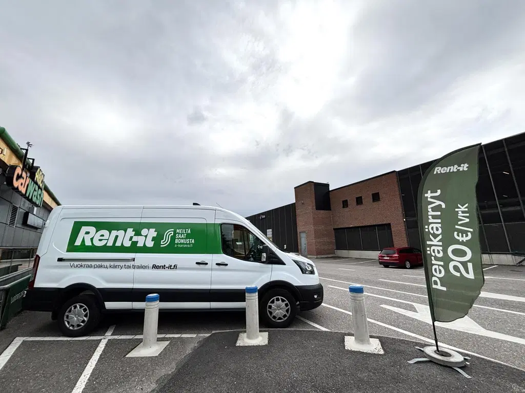 Rent it -vuokrauspalvelun pakettiauto on pysäköitynä ABC Carwashin seinustan viereen. Pakettiauton kylki on kameraan päin.