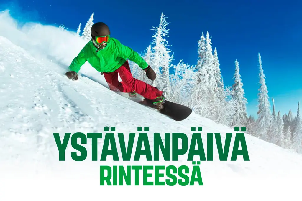 Vihreätakkinen mies laskettelee rinteessä, jonka taustalla on lumisia puita