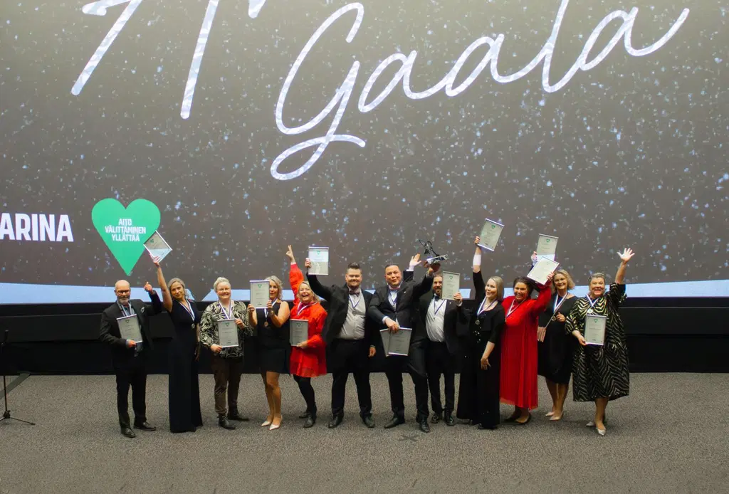 Ihmisiä juhlapuvuissa palkintojen kanssa. Taustalla lukee "Gaala".