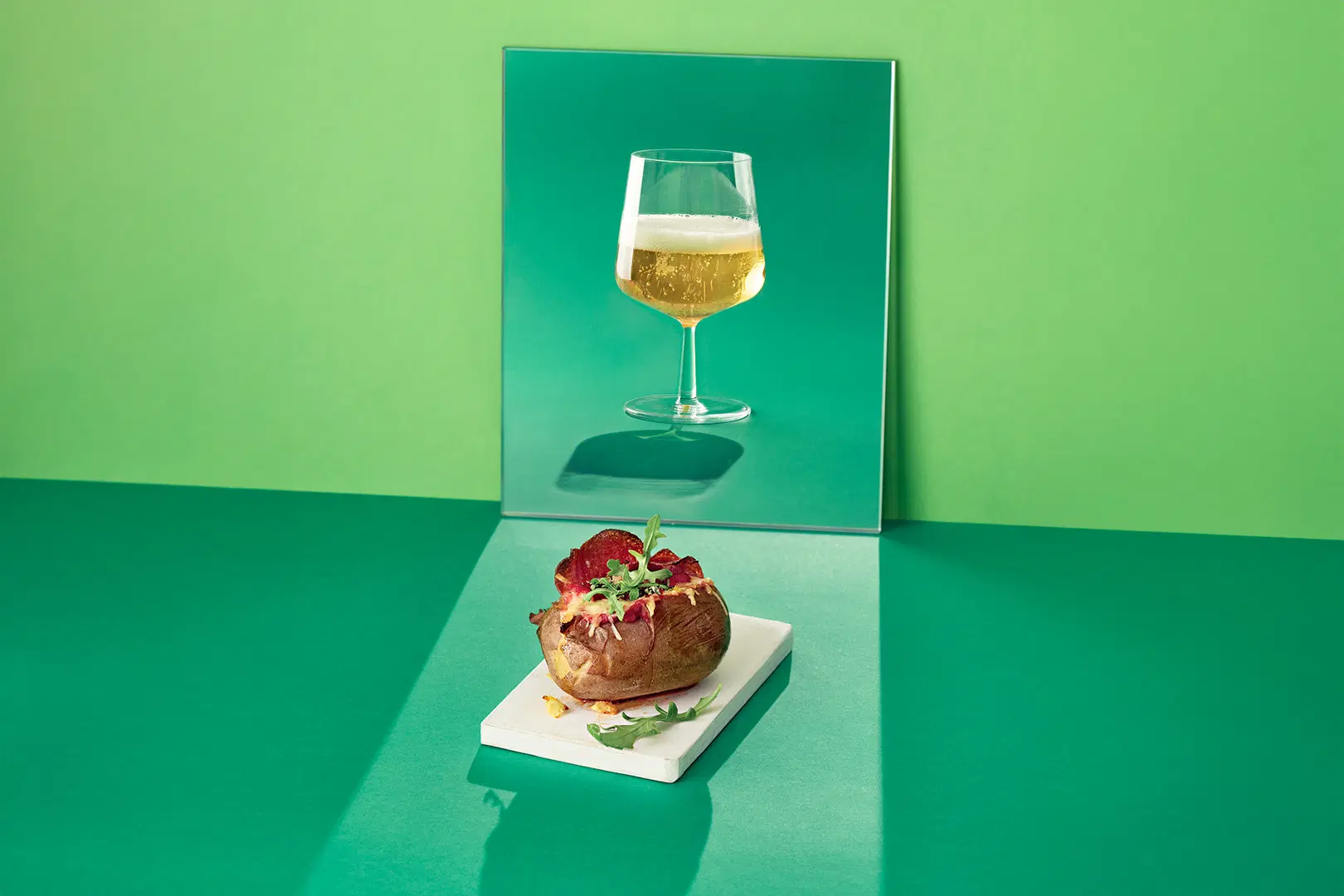 Lasissa olutta ja lautasella uuniperuna, jonka täytteet muistuttavat pizzan makumaailmaa. 