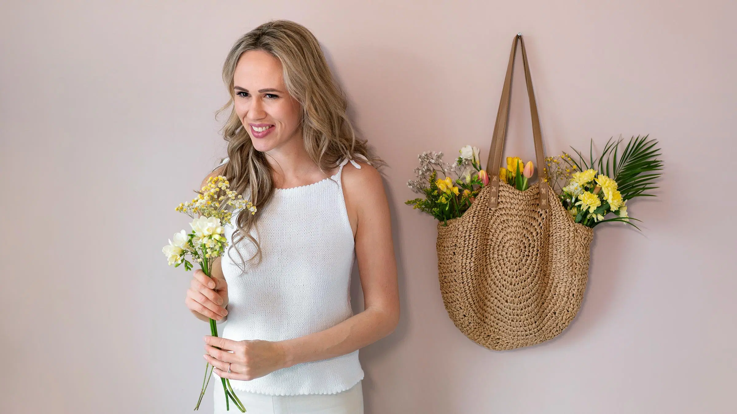 Tiia Holm päällään valkoinen neuletoppi.