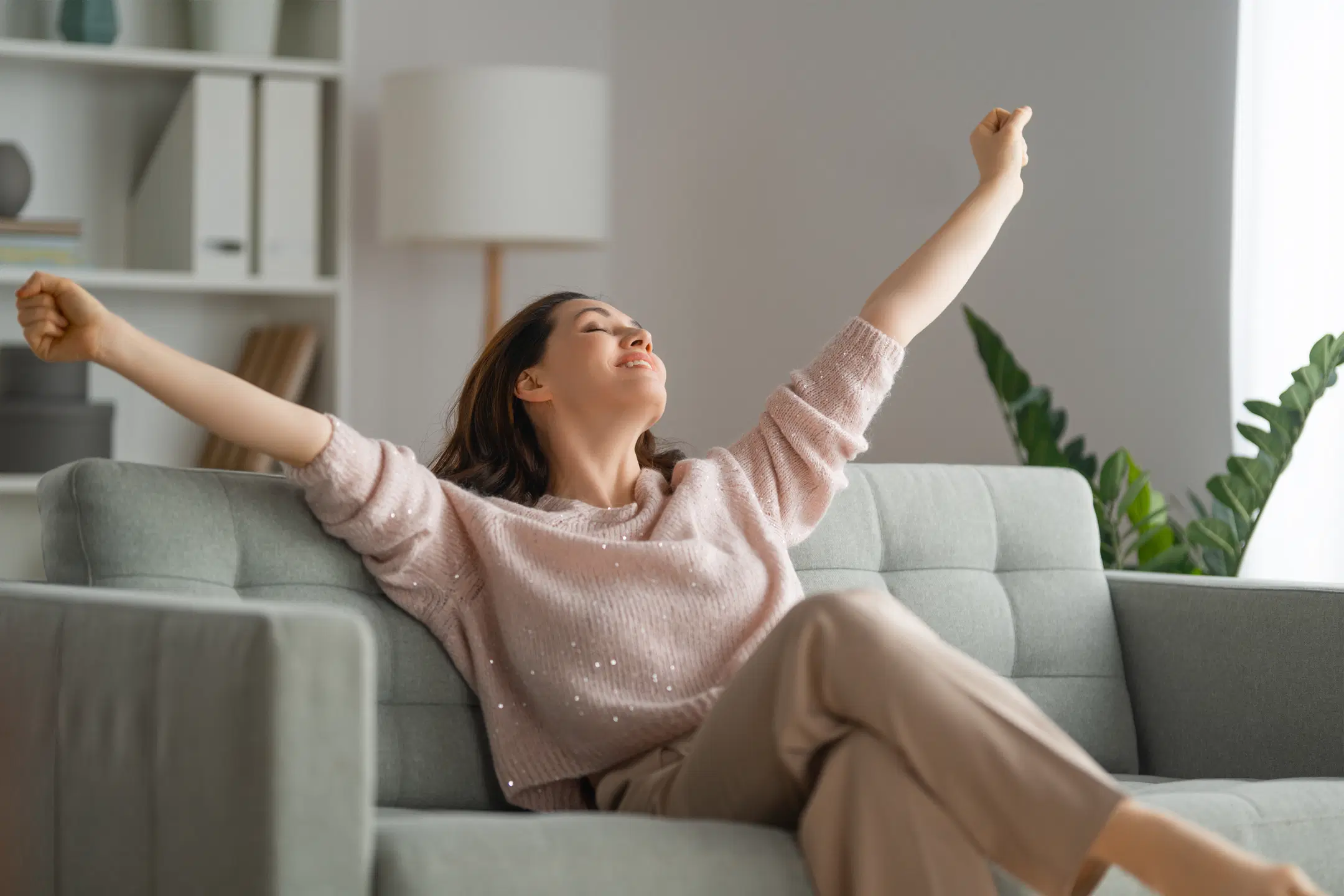 Nainen venyttele sohvalla siistissä kodissa