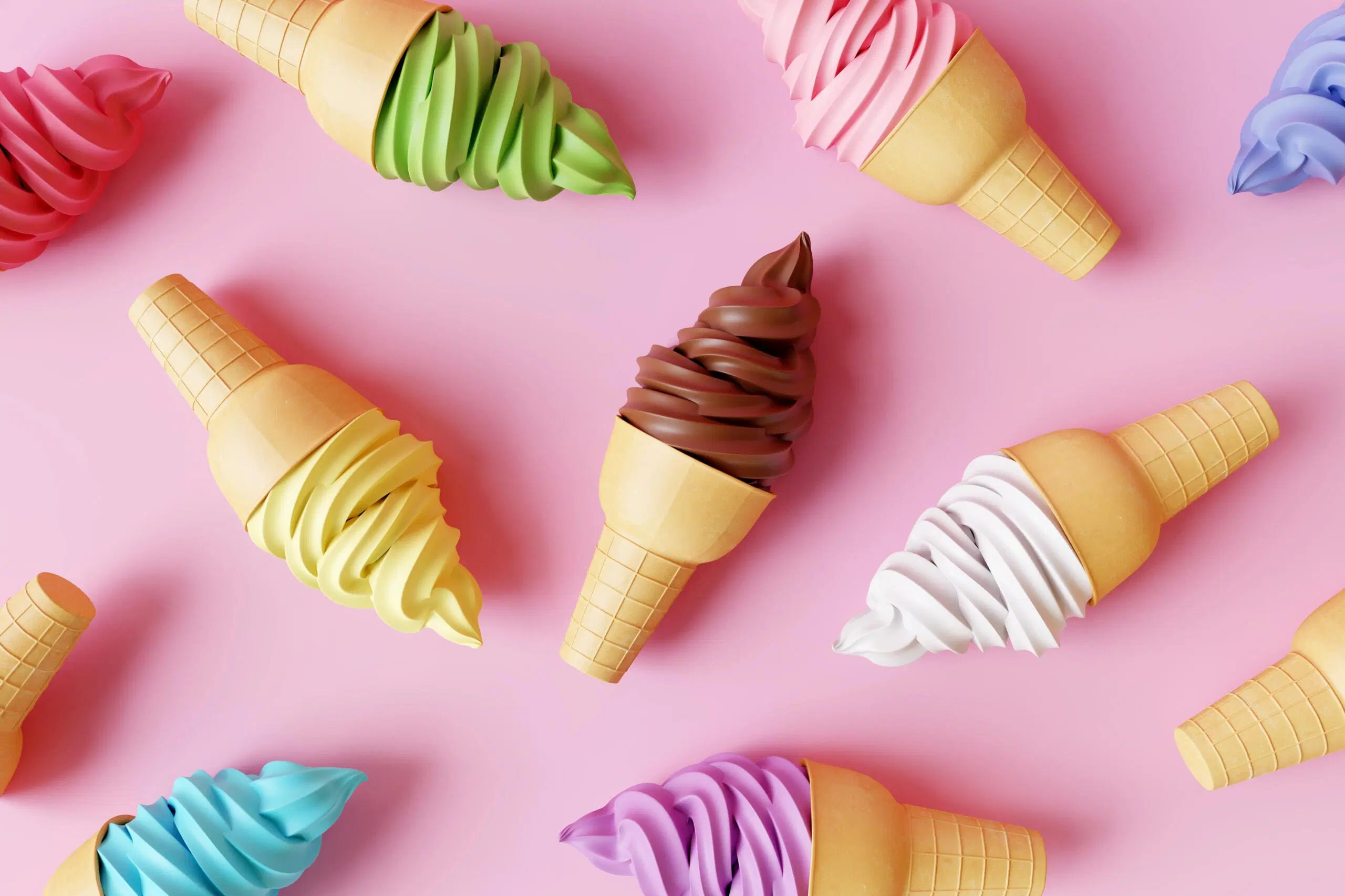 Värikkäitä jäätelötuutteja vaaleanpunaista taustaa vasten
