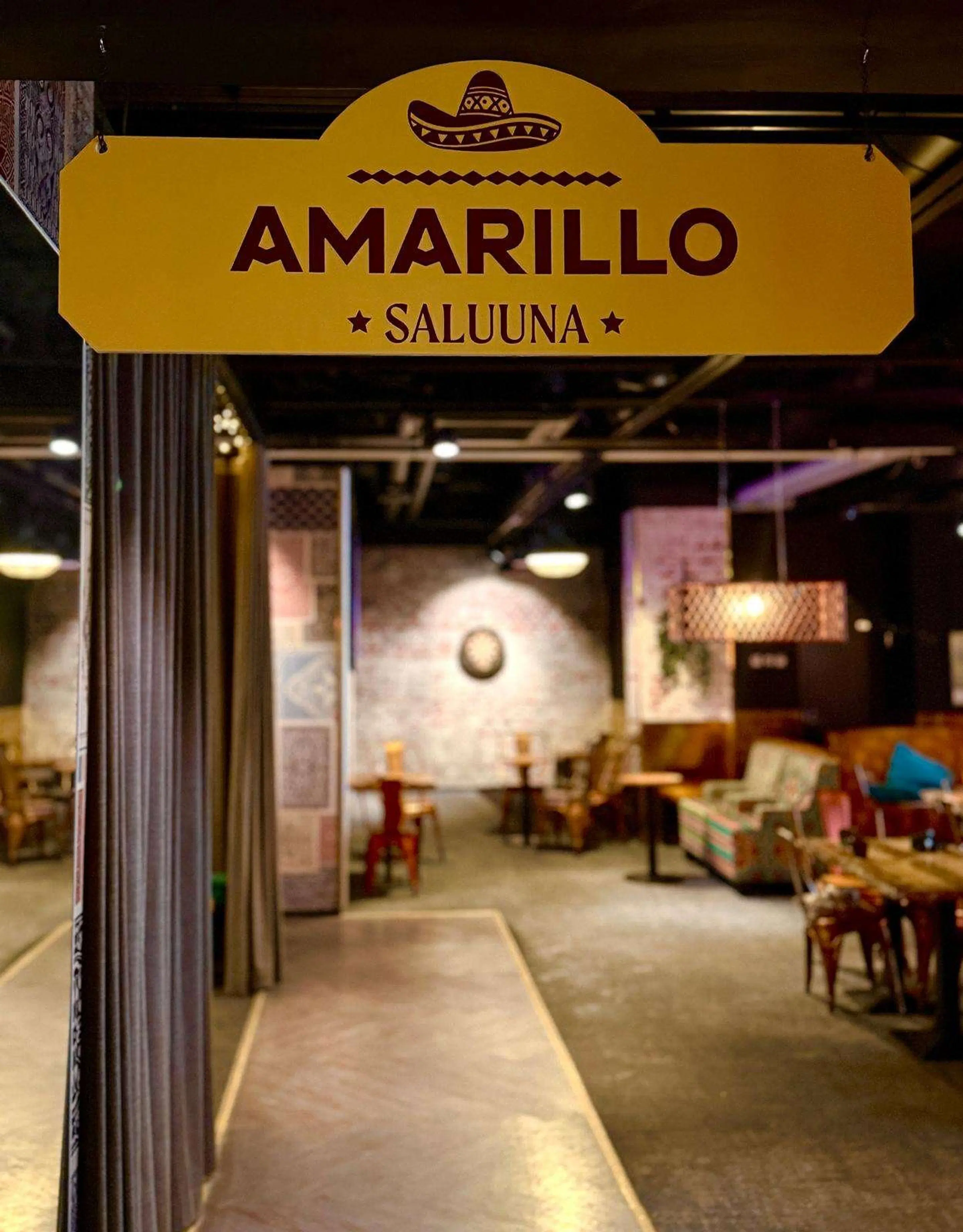 View into restaurant through wide threshold with flat hard concrete floor.