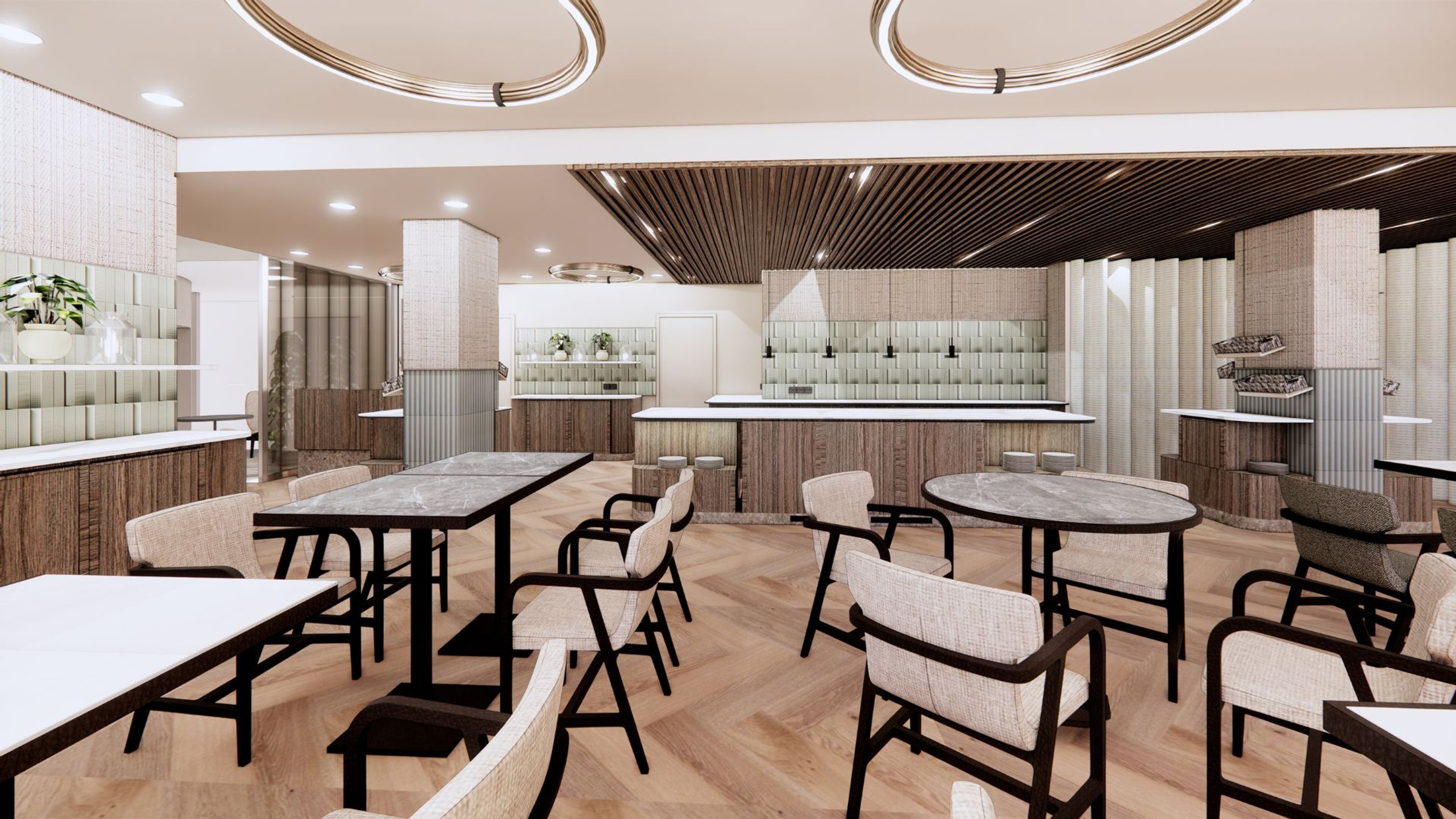 Tyylikkäästi sisustettu kahvila, jossa on puinen parkettilattia, pöytiä ja tuoleja, sekä baaritiski. Tilassa on moderni valaistus ja harmaasävyinen sisustus.