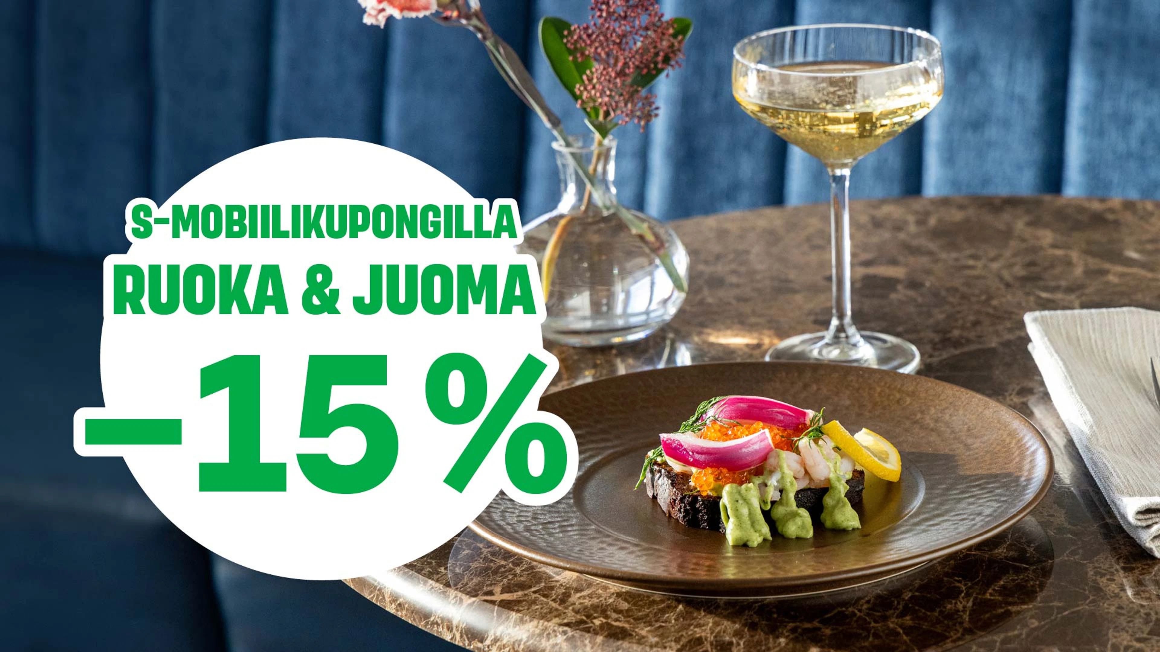 Dish with fresh fish and vegetables served on a brown plate on a marble table. Beside it a champagne glass and a vase with flowers.