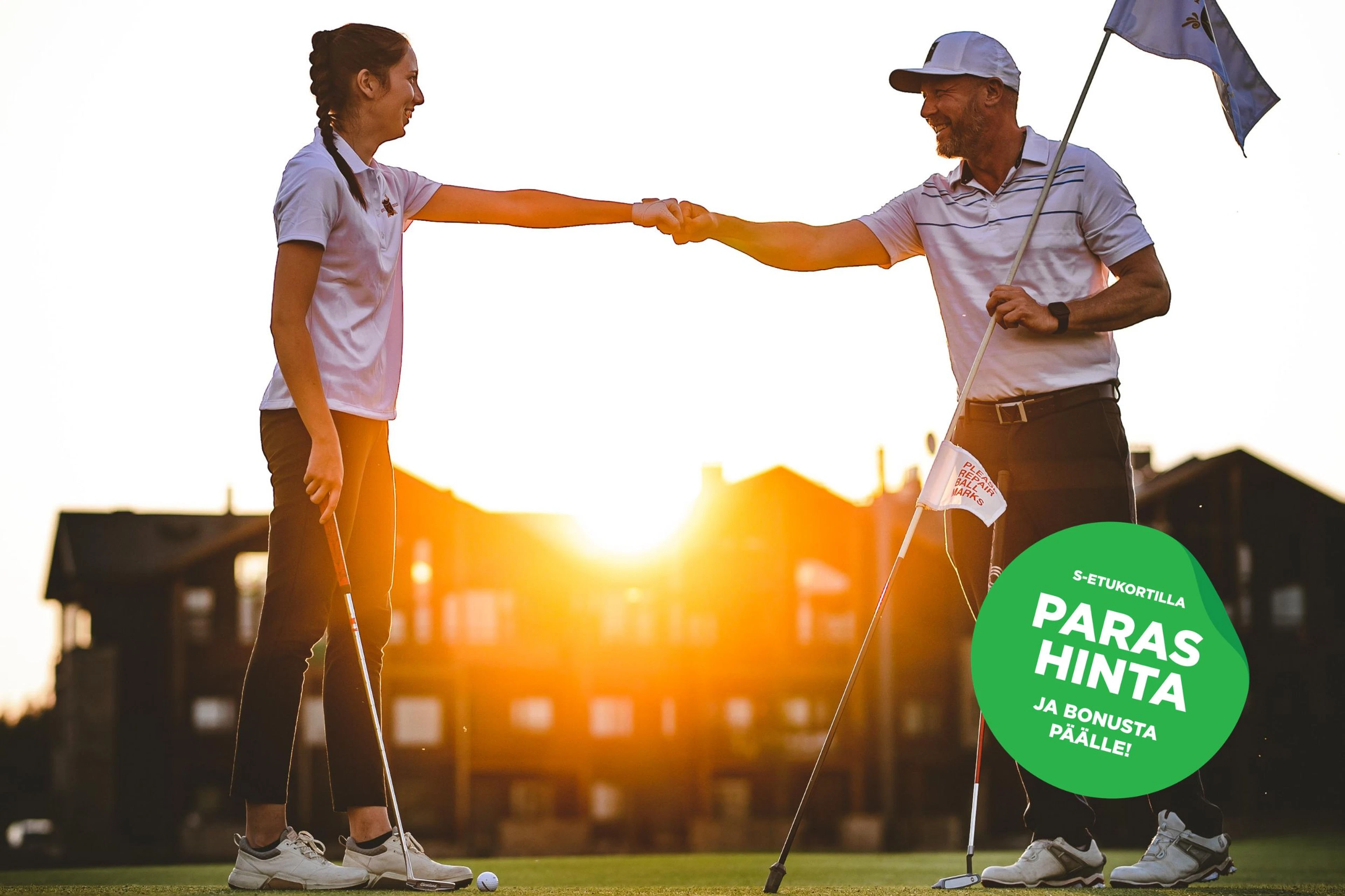 Golf instructor and young player shaking hands on golf course green at sunset.