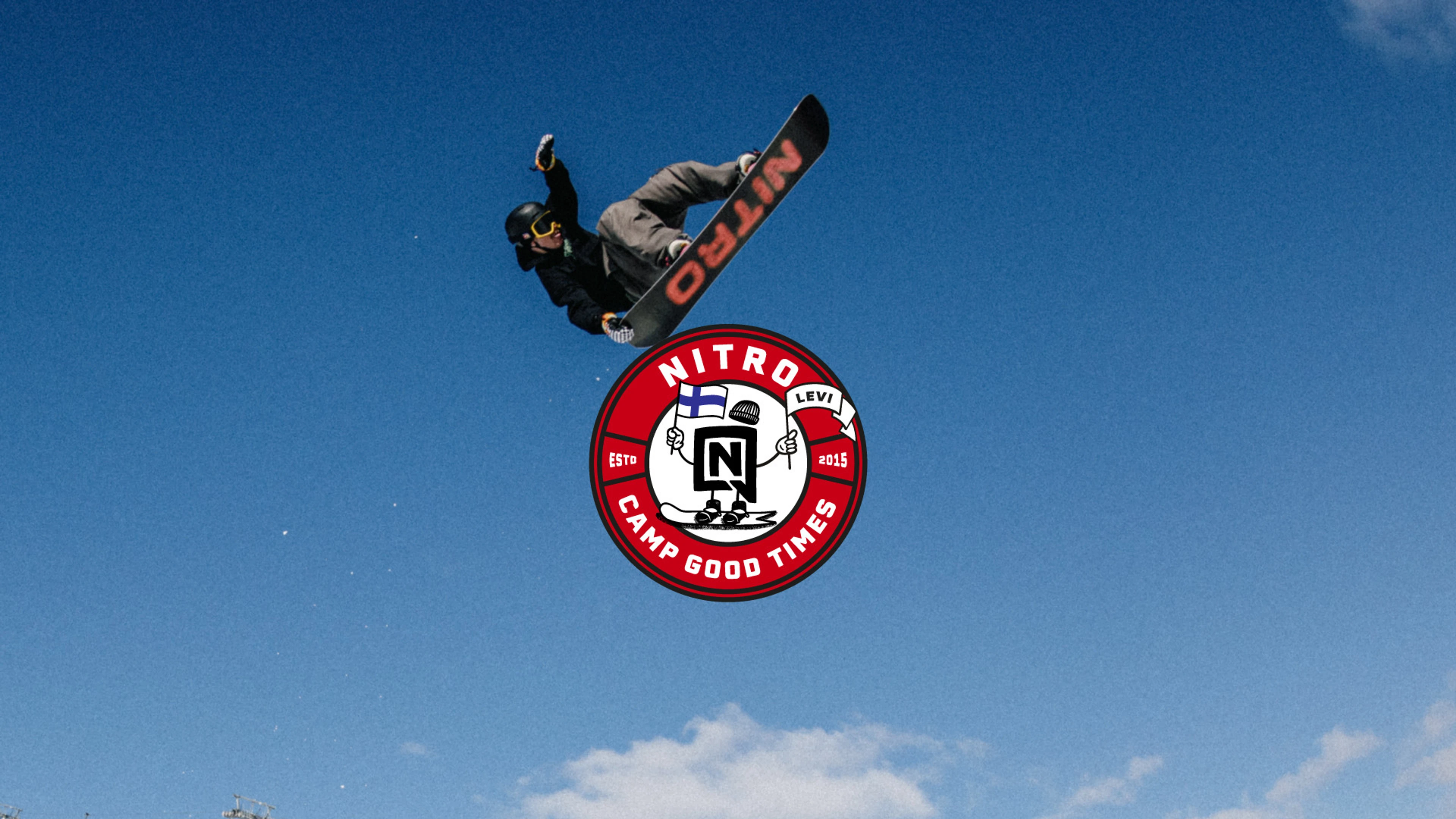 Snowboarder performing a jump against a bright blue sky. Below is a red Nitro brand logo.