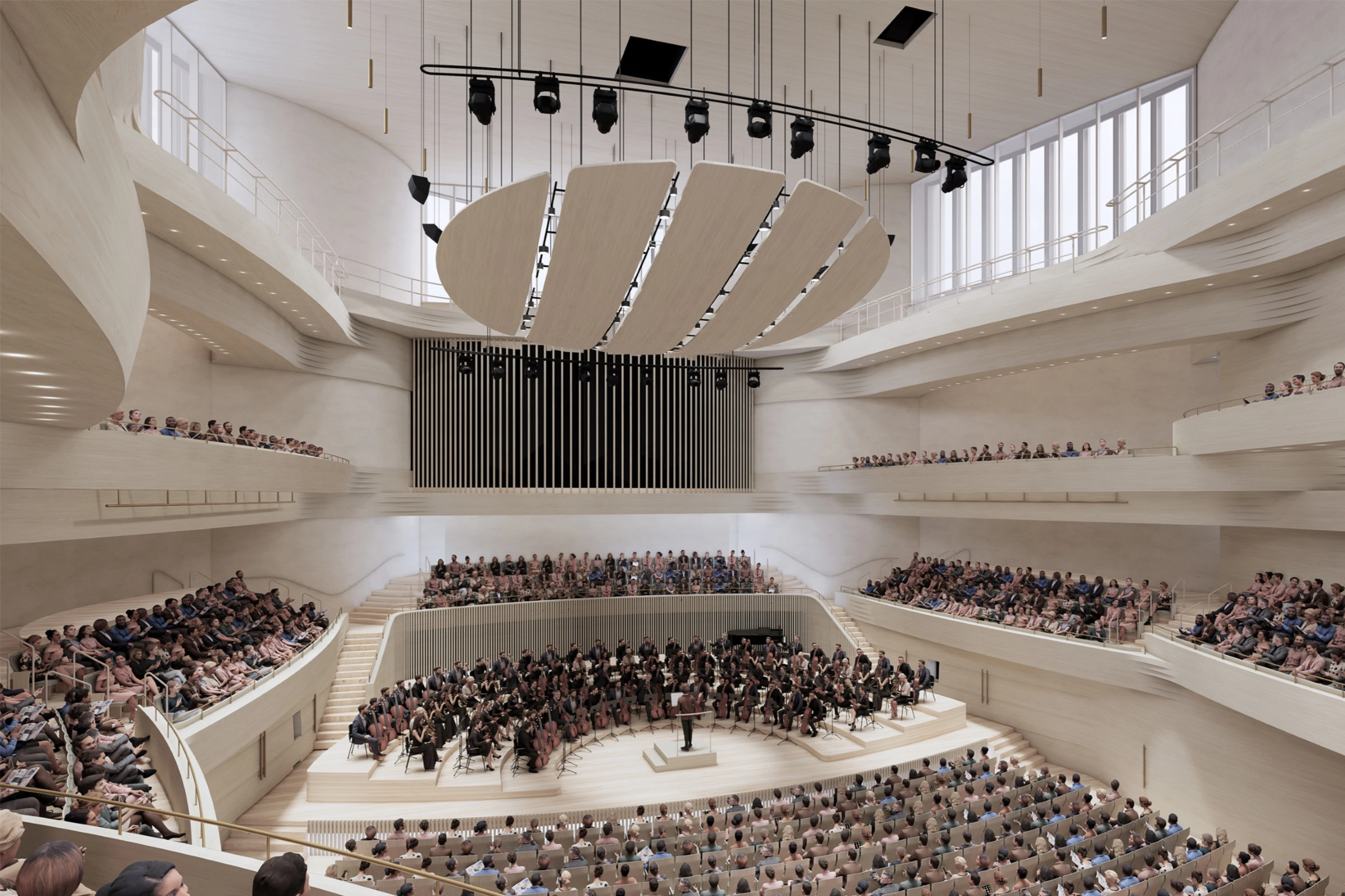 Modern konsertsal med orkester som spelar på scenen. Ljusa ytor, böjd arkitektur och publik på flera nivåer. Stort runt akustiskt element i taket.