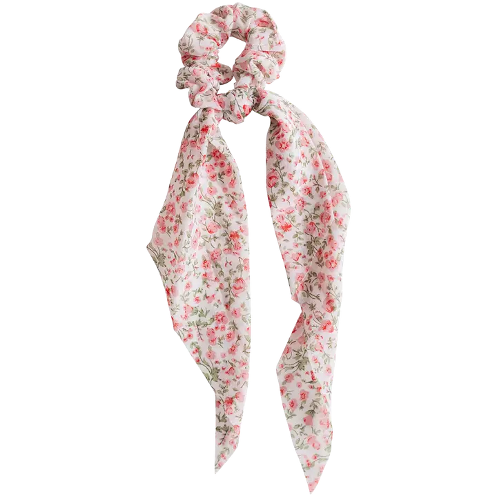 Cailap juuksekumm lilledega seotav