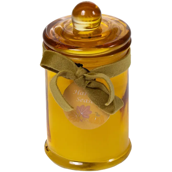 Lõhnaküünal kollases klaaspurgis.