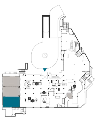 Floor plan shows a building level with varying spaces. The layout includes stairs and elevators.