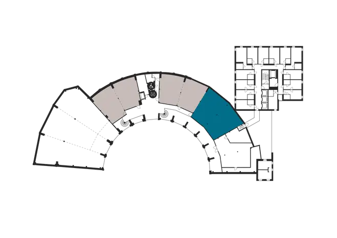 Floor plan showing curved corridor and separate multi-story building section, spaces marked in different colors.